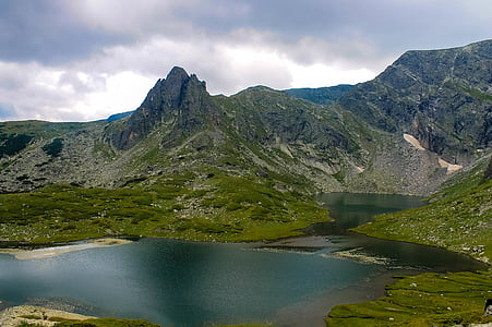 photo of mountains near body of water thumbnail