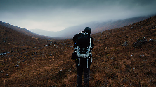 person standing on mountain during daytime thumbnail
