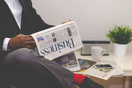 man reading Business newspaper thumbnail