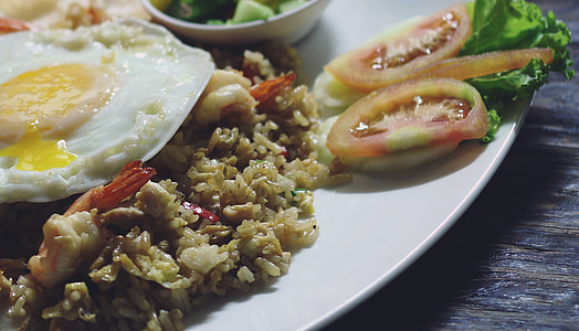 slice tomato beside the rice with sunny side up thumbnail