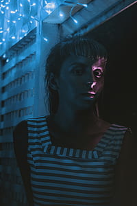 woman in white and black striped dress near white mini lights thumbnail