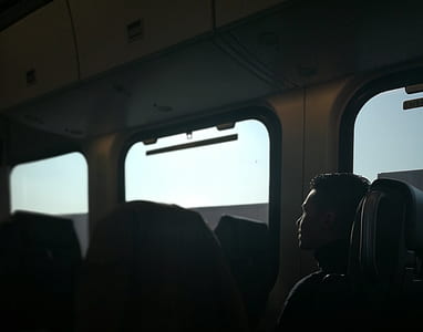 man sitting in train seat thumbnail