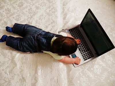 high-angle photography of baby playing laptop thumbnail