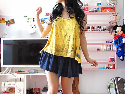 woman wearing yellow and gray tank top and blue skirt thumbnail