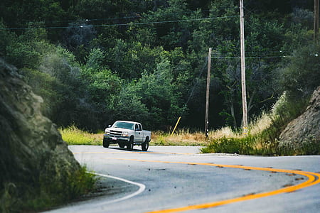 silver pickup truck near rock thumbnail