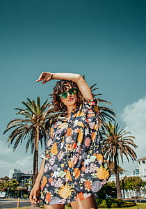 woman wearing black, orange, and green floral button-up shirt thumbnail
