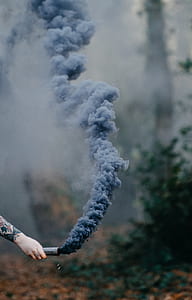 person holding smoke grenade thumbnail