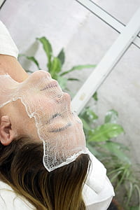 woman lying on bed covered by white net thumbnail
