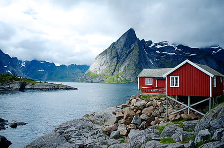 red and gray house in front of lake thumbnail