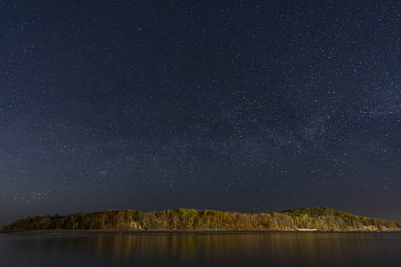 green mountain hill and sea under nighttime thumbnail