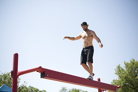 man walking through red steel platform thumbnail