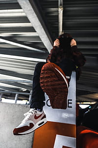 person sits on orange and gray platform thumbnail