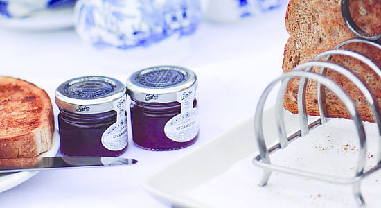two purple cream jars on white table thumbnail
