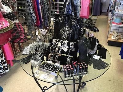 assorted-type accessories on clear glass-top table in room thumbnail