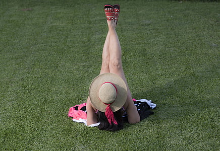 woman lying on green grass field thumbnail
