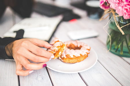 person holding doughnut thumbnail