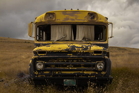 yellow bus under white clouds at daytime thumbnail