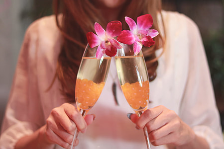 woman holding two champagne glasses thumbnail