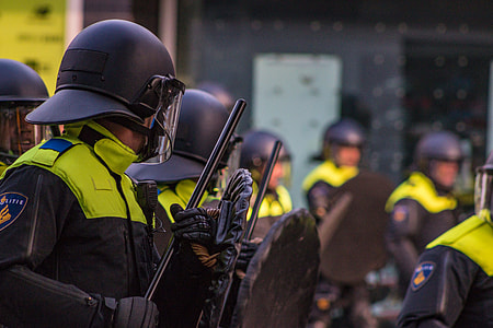 man holding shield with helmet thumbnail