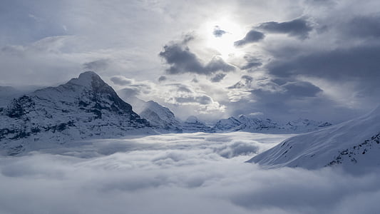 snow mountain peaks under cloudy sky thumbnail