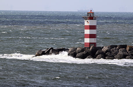 white and red lighthouse tower beside the seashore thumbnail