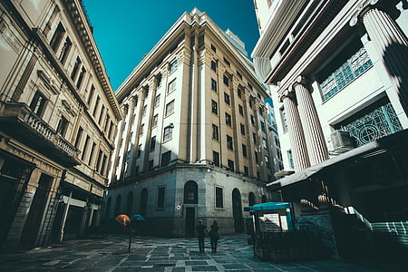 couple standing on pavement near high-rise buildings at daytime thumbnail
