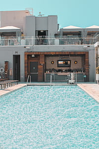 pool in front house under blue sky thumbnail