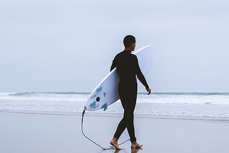 man carrying surfboard walk through beach thumbnail