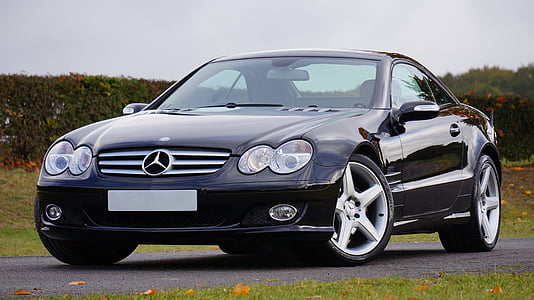 black Mercedes-Benz coupe on grey asphalt road during daytime thumbnail