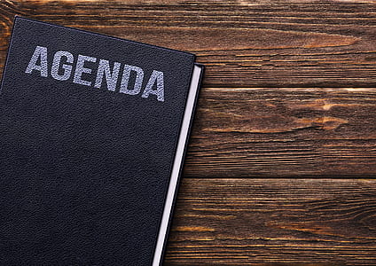 Agenda book on brown wooden surface thumbnail