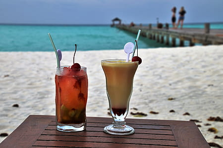 clear drinking glass with juice on table thumbnail