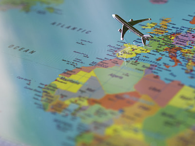 airliner scale model flying over map selective focus photography thumbnail