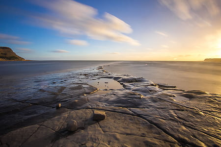 body of water under cloudy sky thumbnail