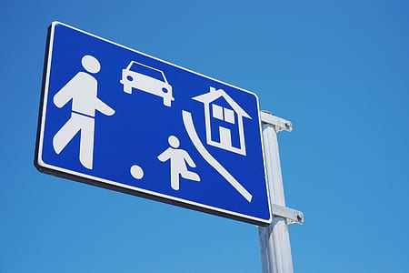 blue and white signage under blue sky thumbnail