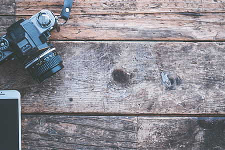 black DSLR camera on brown wood thumbnail