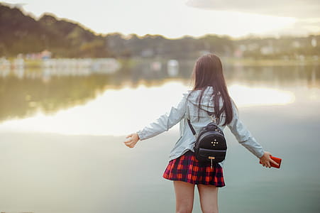 Selective Focus Photography of Girl Near Body of Water thumbnail