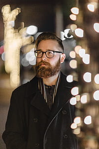 bokeh photography of beaded man wearing double-breasted coat thumbnail