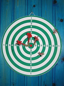 red dart pins pinned on green and white dartboard thumbnail