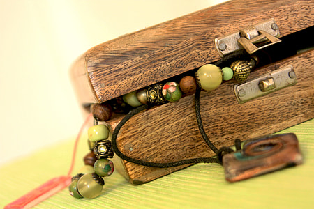 beaded necklace on wooden csae thumbnail
