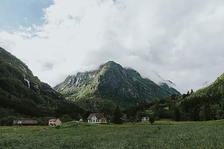 several houses near mountain during daytime thumbnail