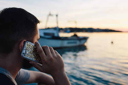 Mobile phone in man's hands near the sea thumbnail