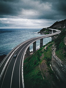 car running on black concrete road thumbnail
