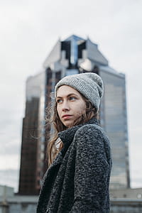 selective focus photography of woman in gray cardigan and knit cap thumbnail