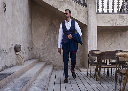 Man Standing Beside Brown Concrete Stairs thumbnail