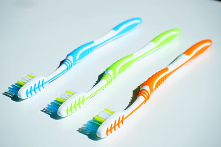 three blue, green, and orange toothbrushes screenshot thumbnail