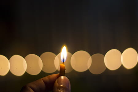 person holding yellow candle stick thumbnail