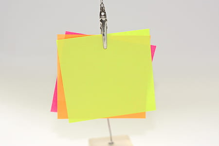 three assorted-color papers on metal clip thumbnail