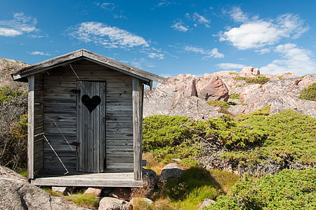 brown wooden shed on mountains thumbnail