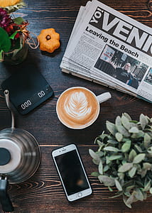 espresso coffee with newspaper and smartphone on brown table thumbnail
