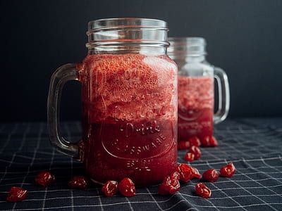 Mason Jar Filled With Cranberry Juice On Black and White Checked Cloth thumbnail